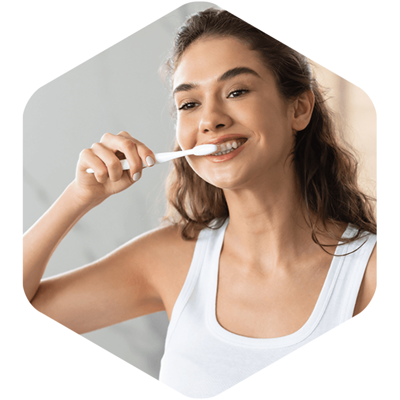 Woman brushing her teeth.